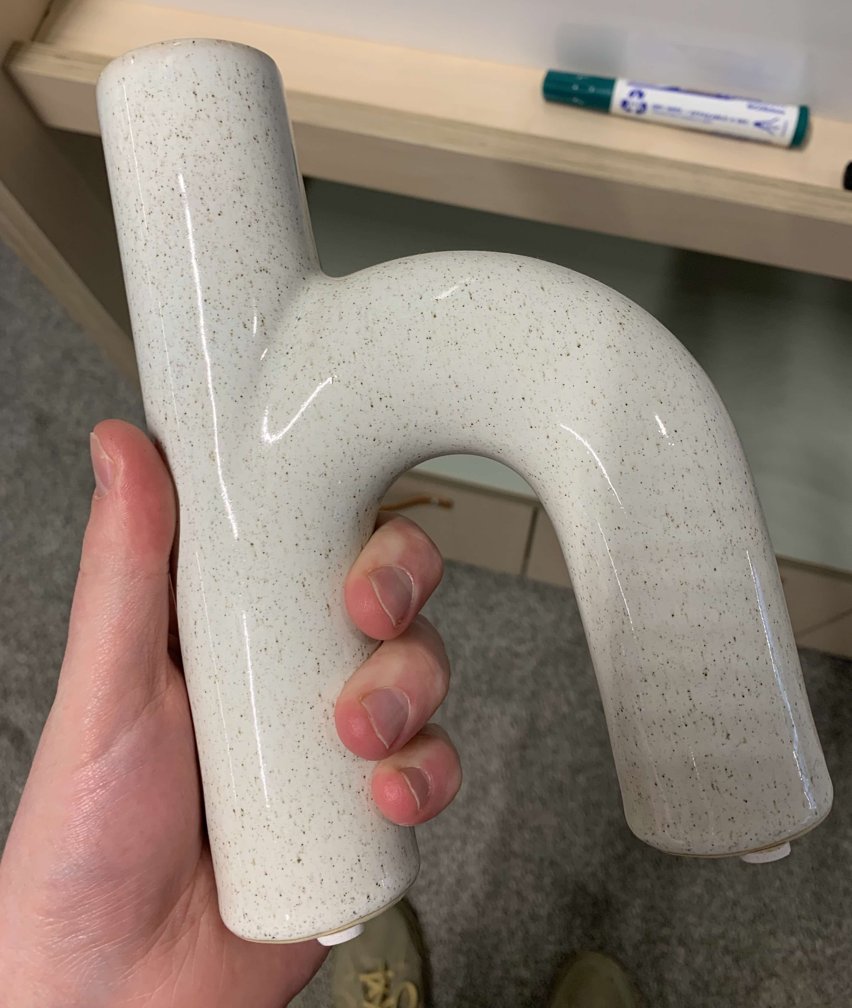 Photograph of a vase in the shape of the letter 'h.'